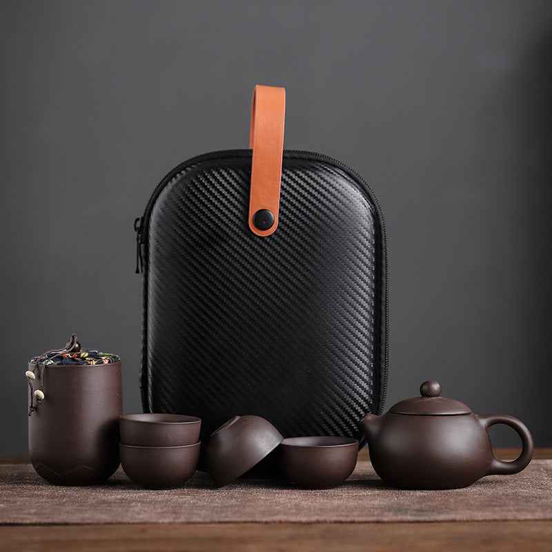 “Travel tea set in use – compact and stylish Yixing clay teaware for home, office, or outdoor travel”
